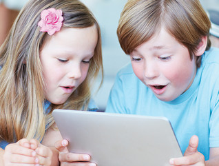 Two kids using a tablet for digital learning 