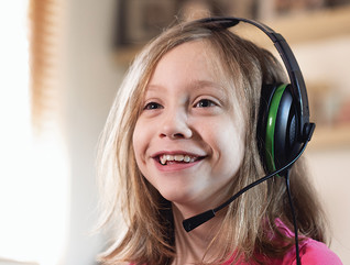young girl smiling with gaming headset on 