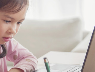 Girl with headphones on laptop 