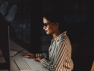 IT leader in front of computer screen in dark room cybersecurity