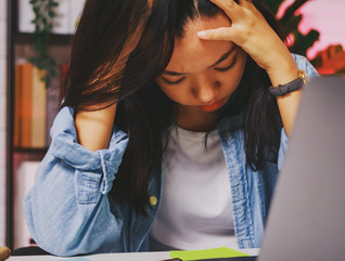 Student with head in hands at computer - content filtering