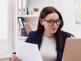 Admin auditing at laptop in office