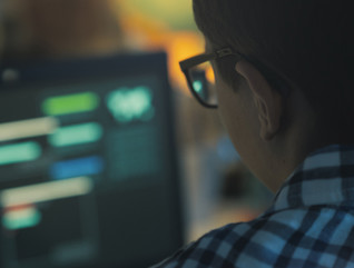 Student with glasses using computer for cyber attack