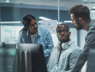 IT leaders discussing cybersecurity insurance around computers