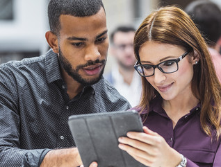 Technology leaders examine tablet in event hall