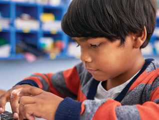 young student using a laptop in classroom