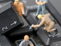 Miniature figurines work on computer keyboard