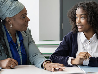 Teacher working closely with student