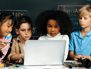 Students crowded around a laptop