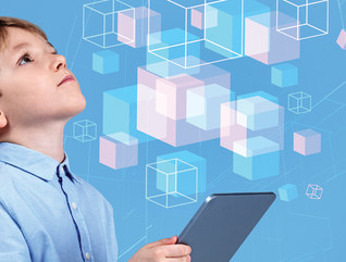 little boy holding tablet and looking at illustrated floating cubes