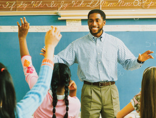Teacher at the chalkboard calling on students
