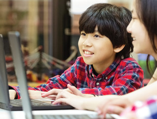 Students using laptops in school