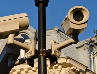 Security cameras installed on pole in front of historic building