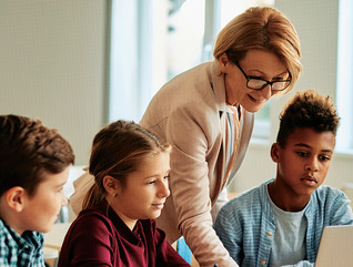 Teacher assisting students in the classroom