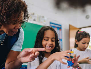 Teacher helping students during art class