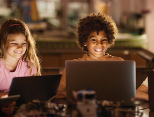 Students learning on laptop computers in a K12 classroom