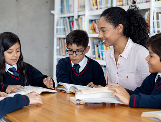 Teacher working with students at a private school