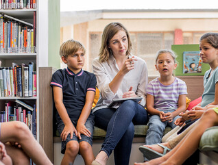 Teacher holding class in the library