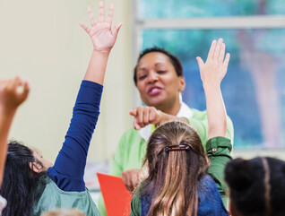 Teacher and students in elementary school classroom