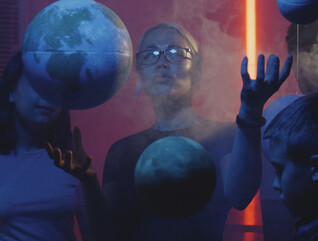 Teacher teaching astronomy with planet models