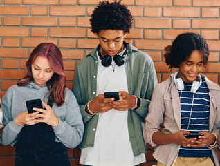 Students looking at phones in school