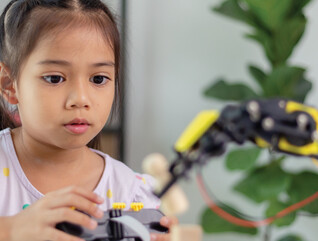 K12 student working on steam project with robot