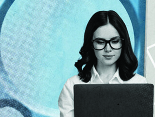 Person using laptop with gears in the background