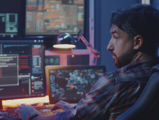 Security alerts appearing on multiple screens while man watches