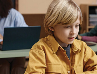 Boy on Laptop in classroom