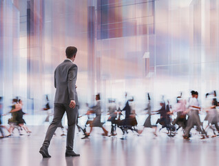 man walking in front of crowd