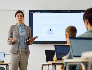 Teacher instructing class with technology
