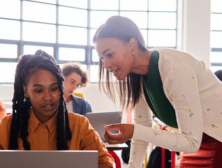 Teacher helping student in class