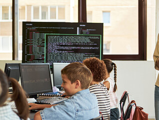 Teacher observing students in a classroom