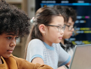 Students using laptops in school