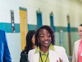 Diverse group of educators walking in hallway