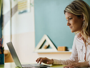 Teacher using laptop