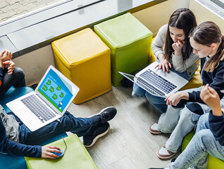 Students using computer in classroom