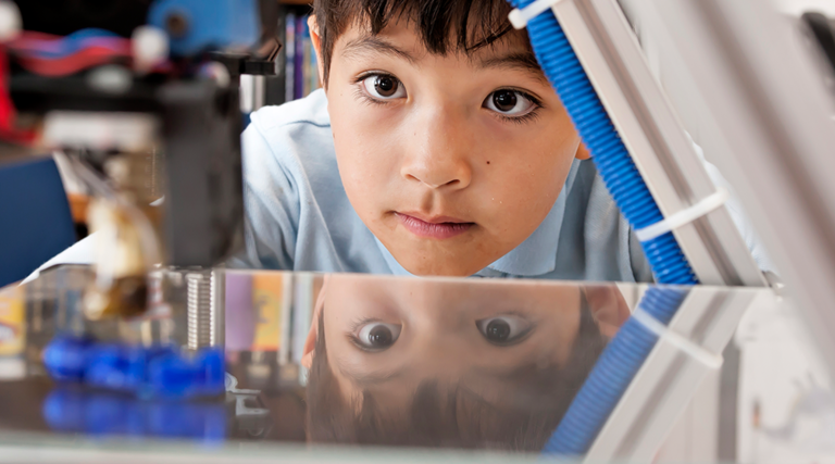 Boy watches 3d printer