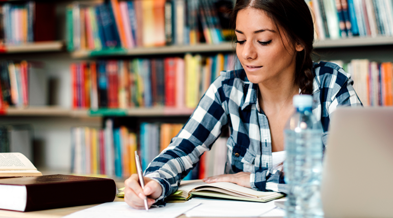 Student using laptop for taking notes to study