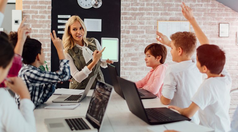 Kids engaged in class with teacher and education technology