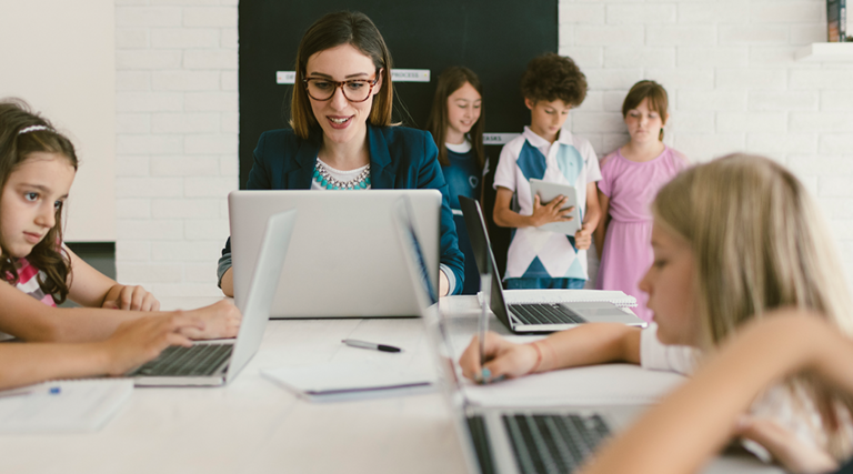 Students and teacher on computers