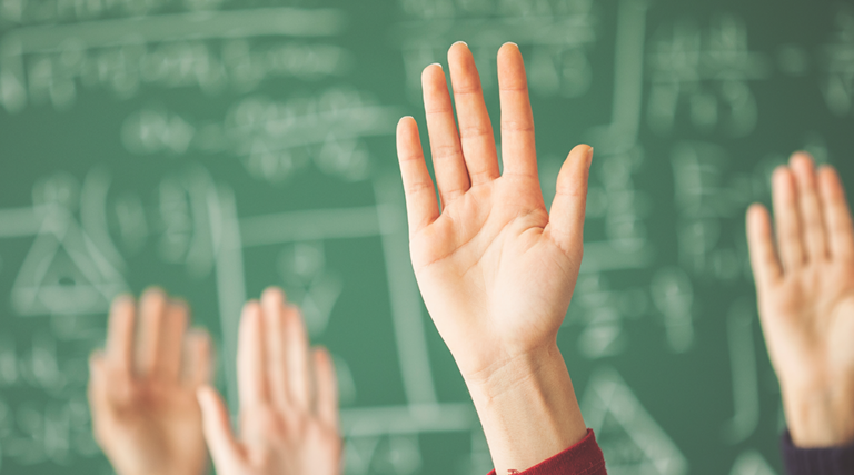 Hands in a classroom