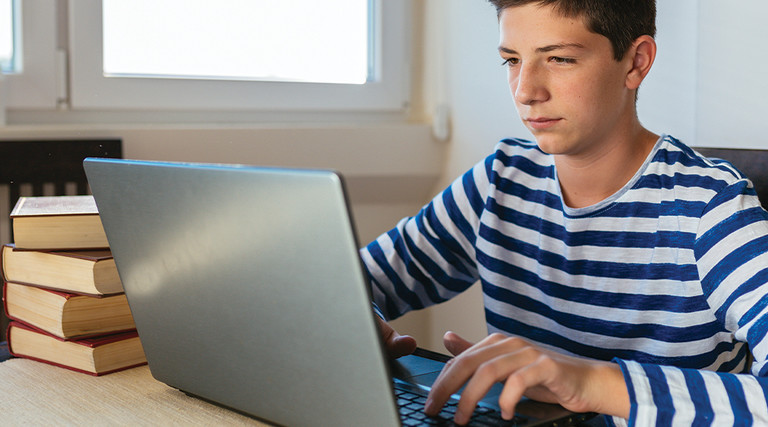 boy using laptop at home