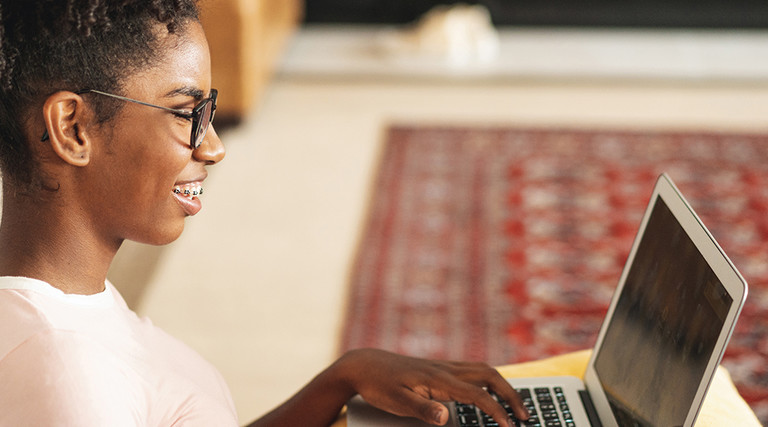 teenage girl using laptop