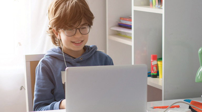 boy using laptop at home