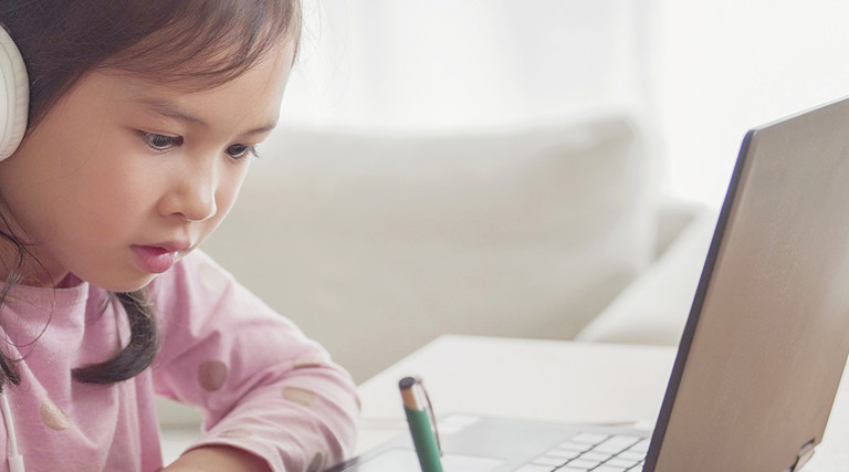 Girl with headphones on laptop 