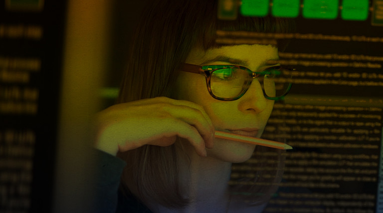 Person conducting threat assessment, looking at data, cybersecurity