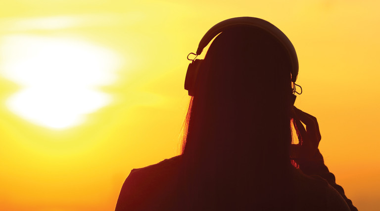 student using headphones silhouette