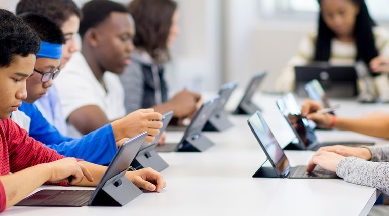 Students working on tablets in classroom