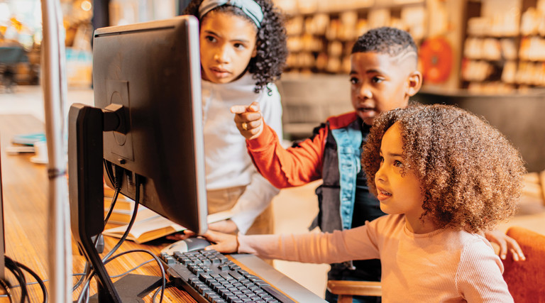 Students using a computer in class